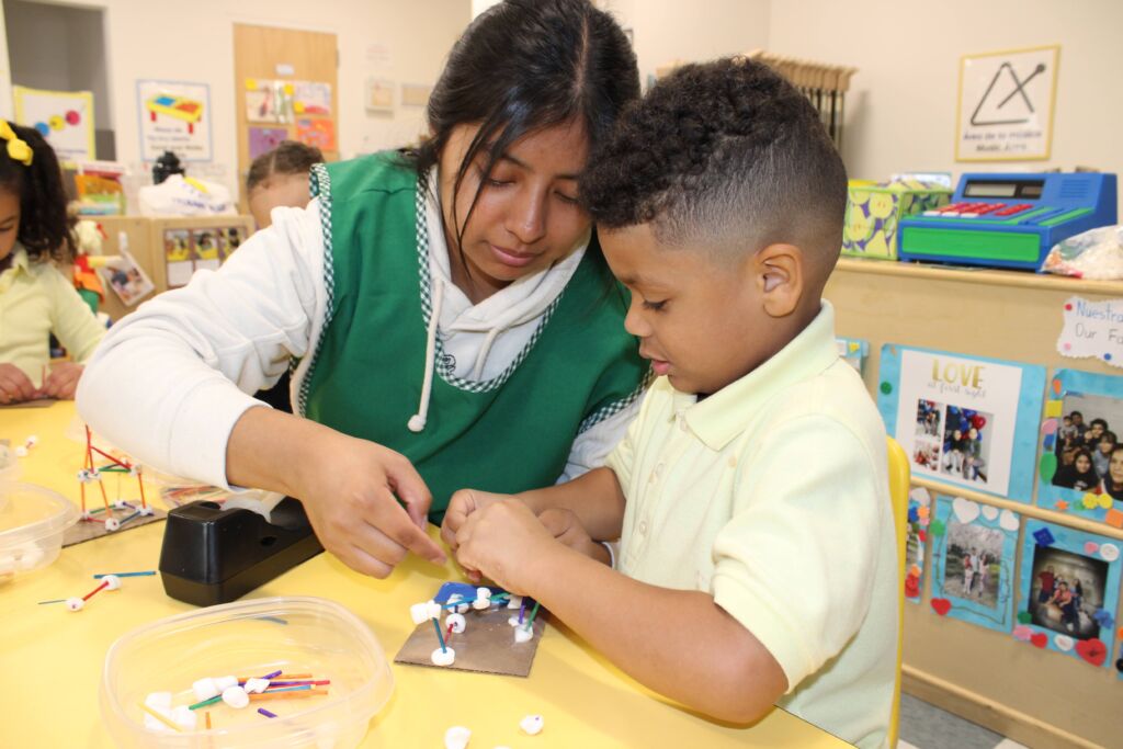 Children's Day student and teacher working on crafts together.